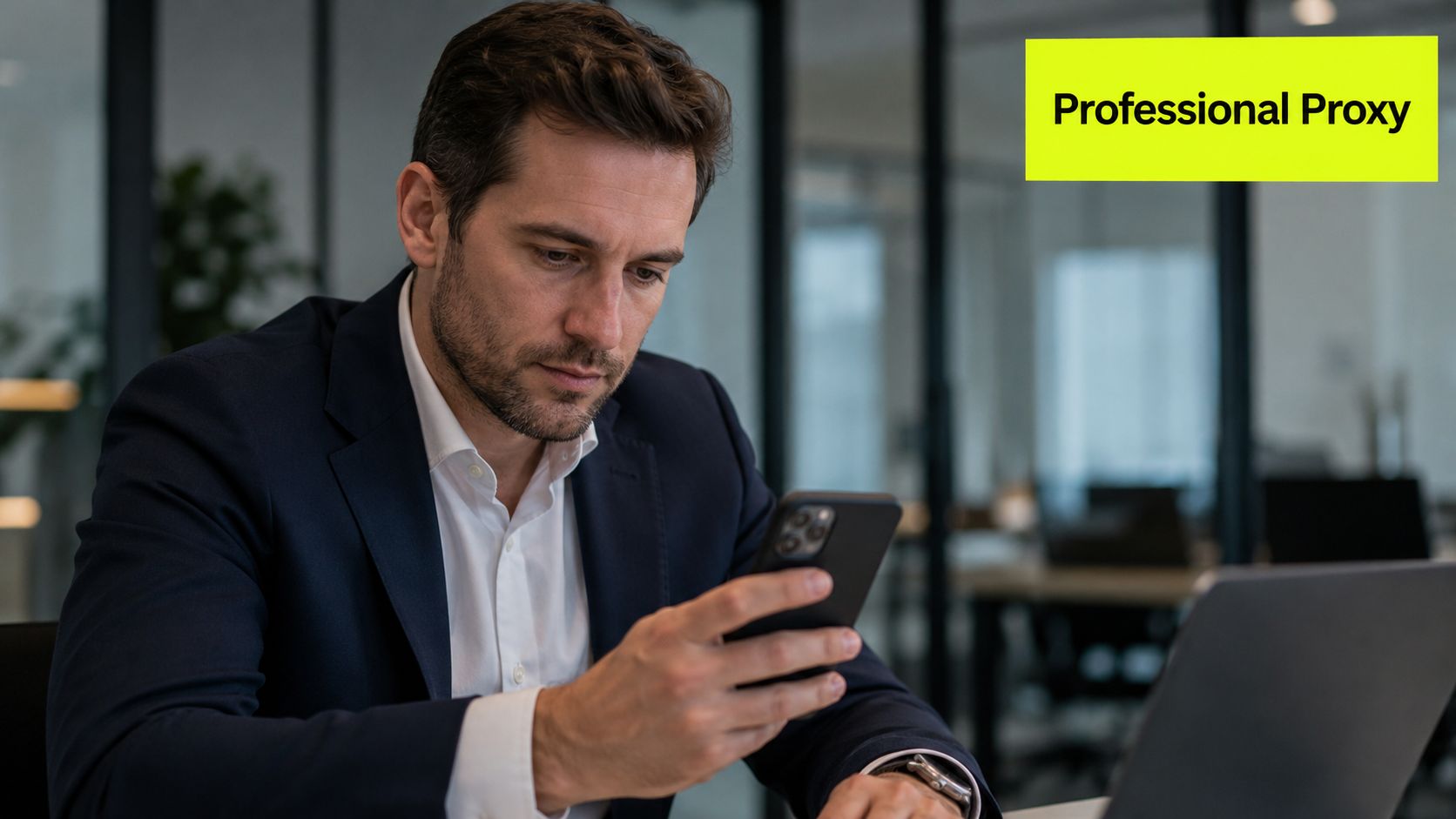 A professional man in a business suit using his smartphone while sitting at an office desk.